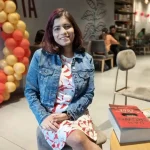 i girl sitting behind decoration of balloons